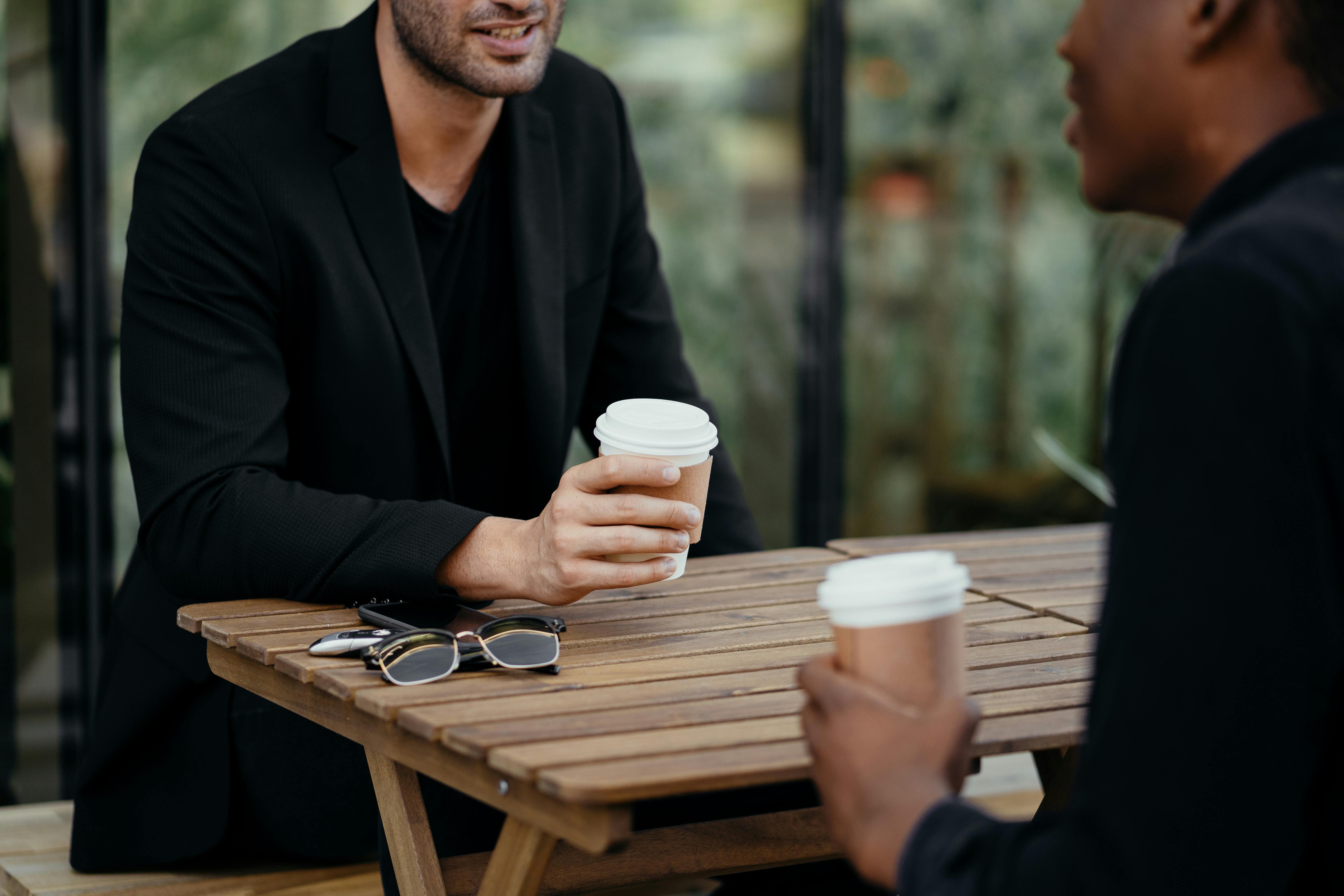 two-people-talking-pver-coffee